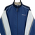 VINTAGE 90S REEBOK SPELLOUT TRACK JACKET IN NAVY, BEIGE & WHITE - MEN'S SMALL/WOMEN'S MEDIUM